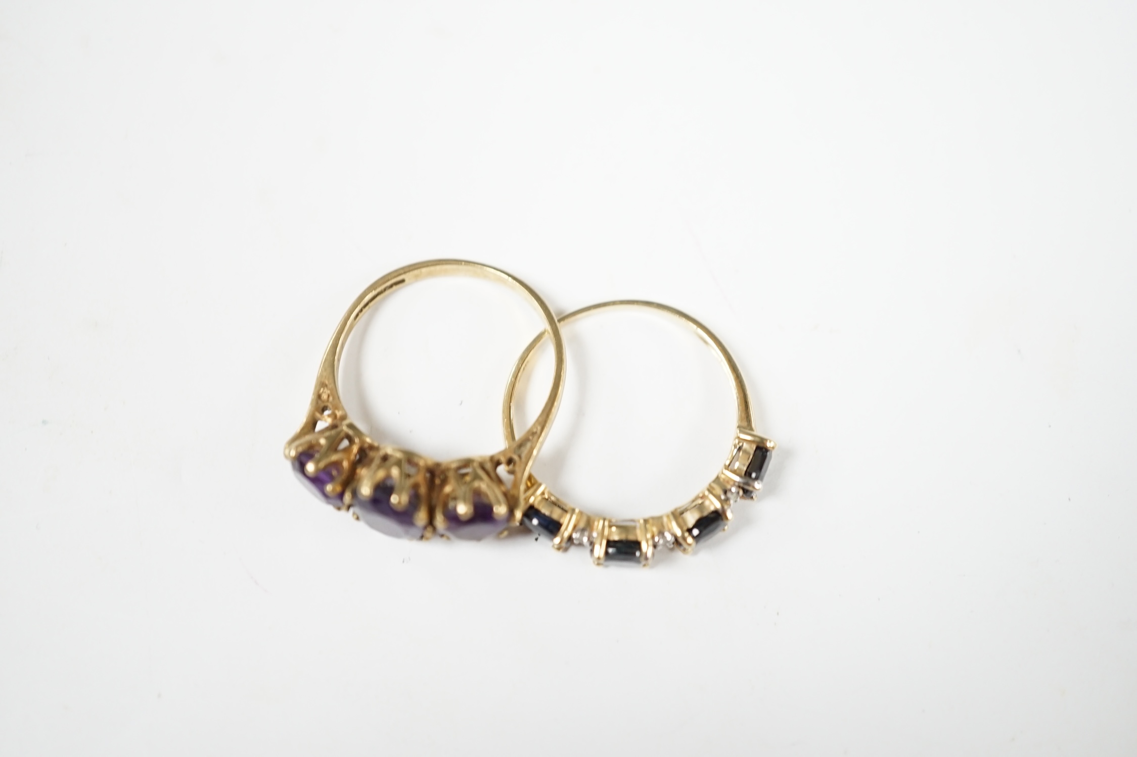 Two modern 9ct gold and gem set rings including three stone amethyst, size O and sapphire and diamond chip half hoop, gross weight 4.9 grams. Condition - fair